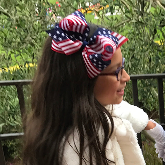 Big red, white & blue hair bow on a little girl