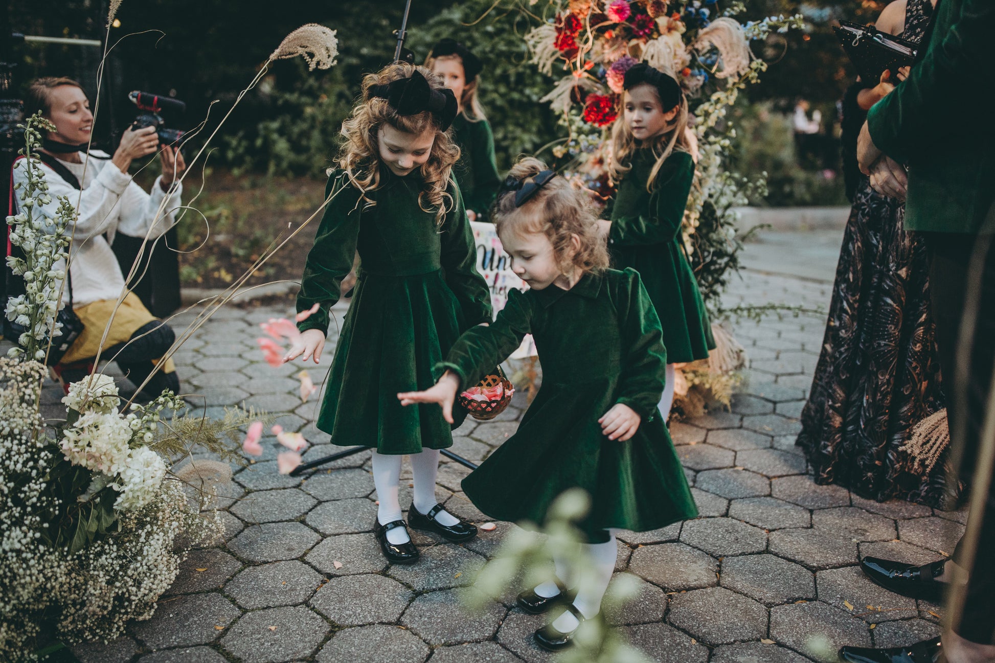 Little girls dancing in green velvet dresses.